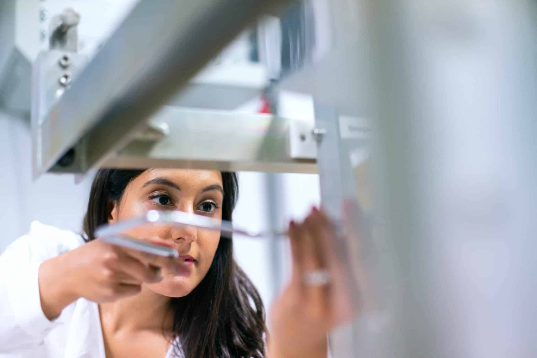 image of automation expert adjusting customer equipment at factory